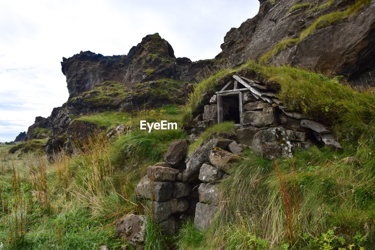 Built structure on cliff against sky