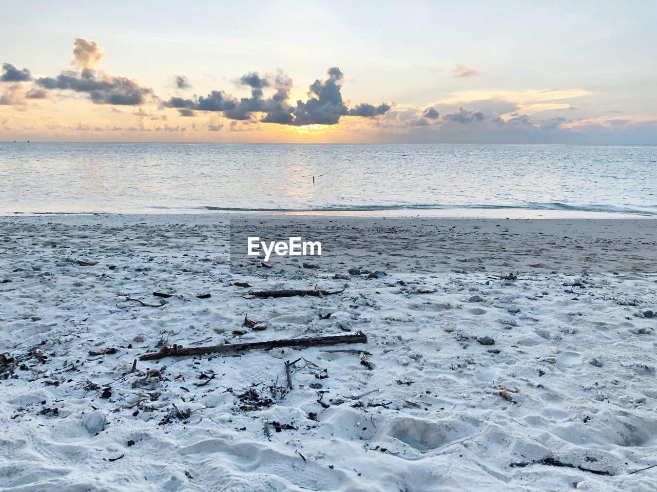 SCENIC VIEW OF BEACH DURING SUNSET