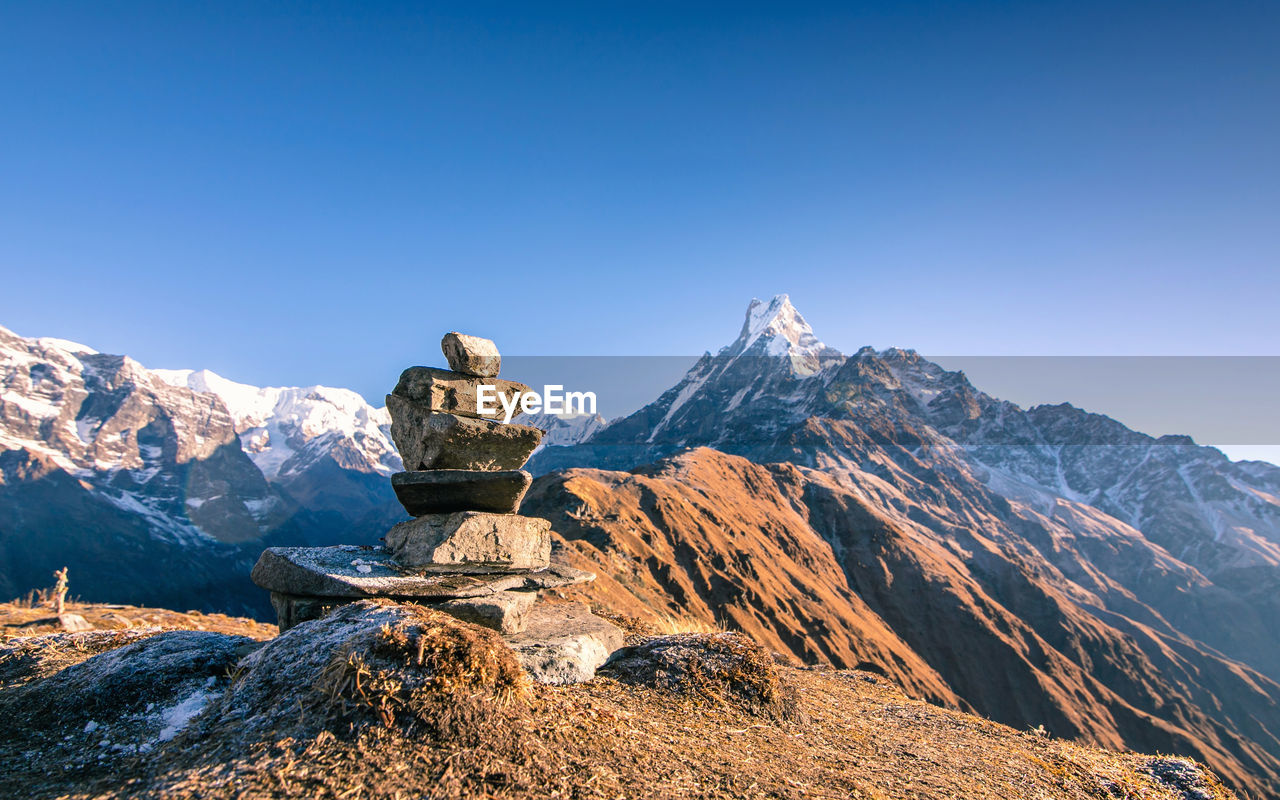 Scenic view of snowcapped mountains against clear blue sky