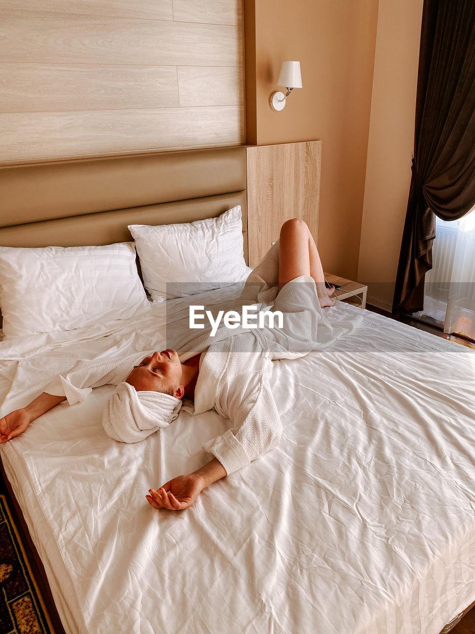 High angle view of young woman sleeping on bed at home