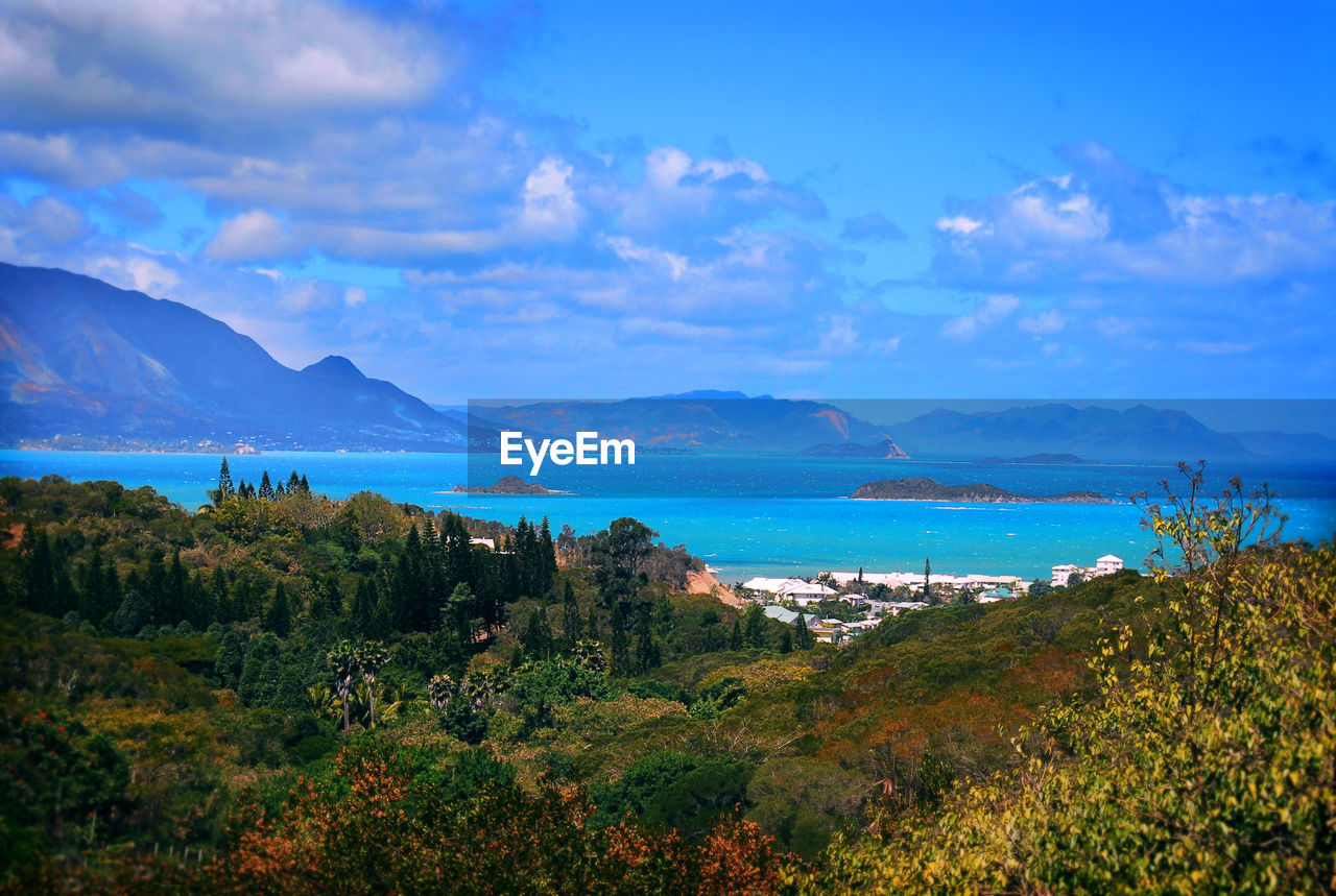 Scenic view of sea and mountains against sky