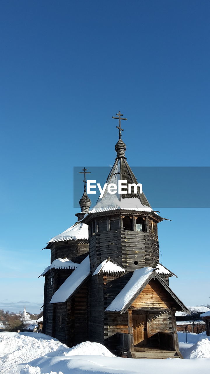 BUILDING AGAINST CLEAR BLUE SKY