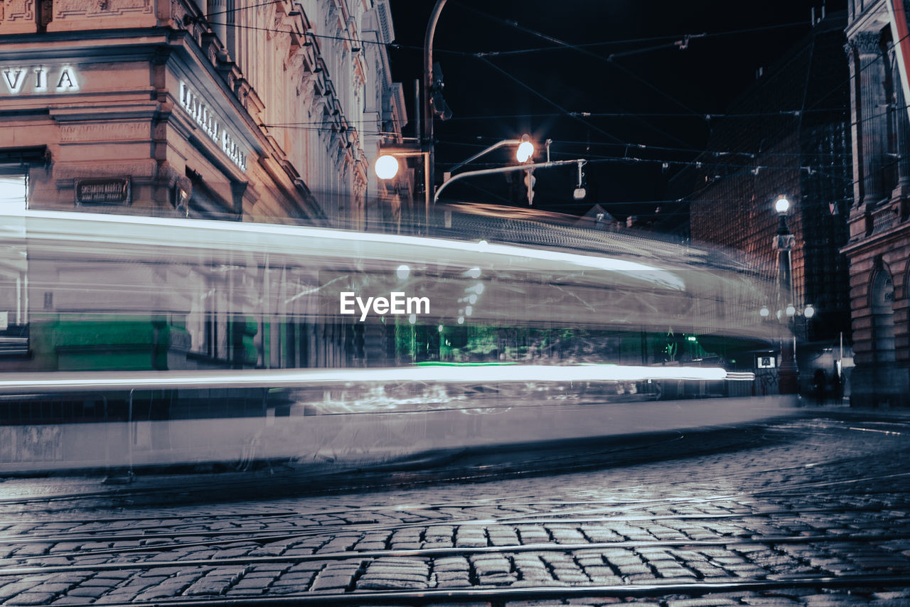 LIGHT TRAILS ON STREET IN CITY