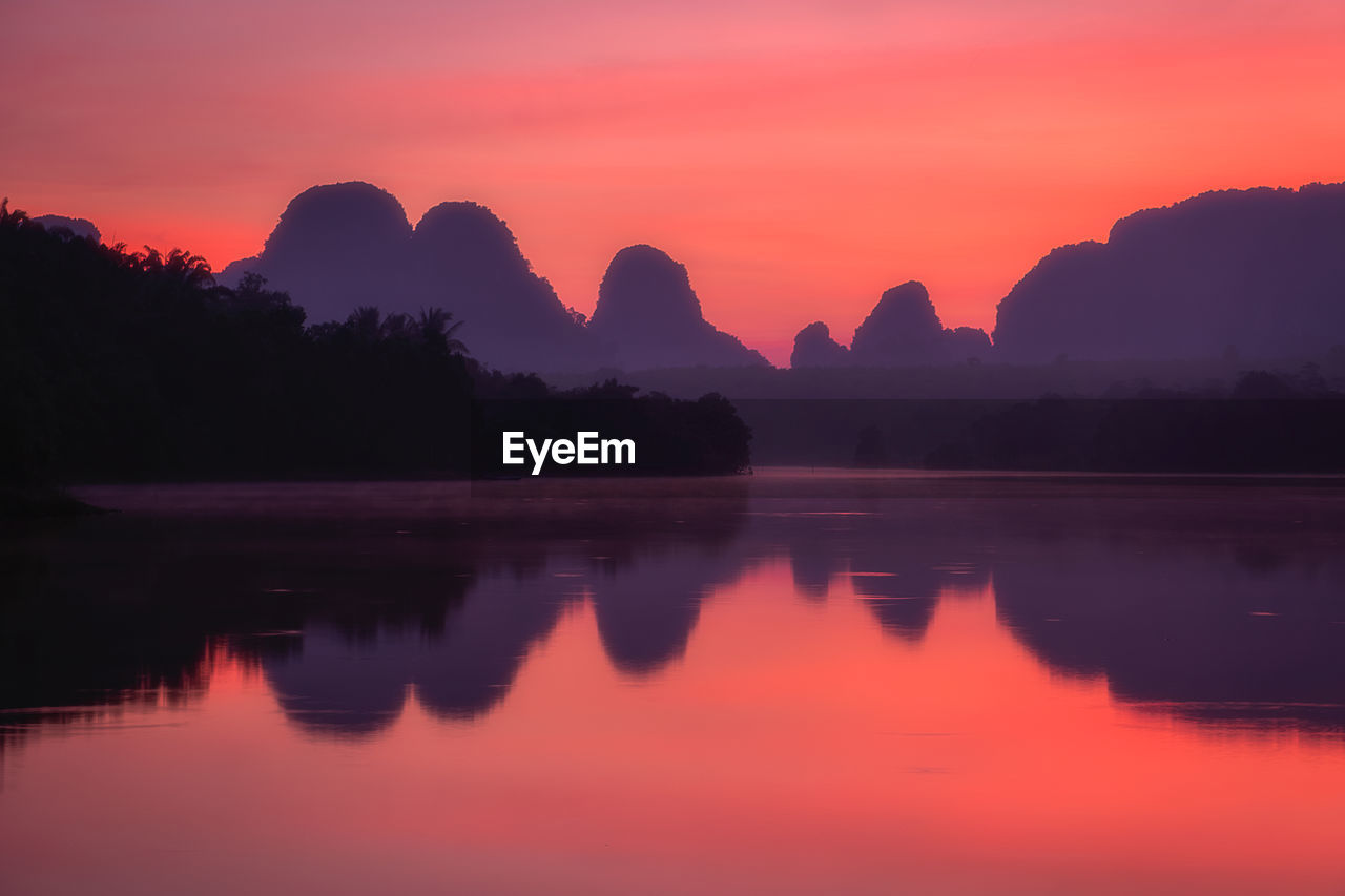 Scenic view of lake against romantic sky at sunset