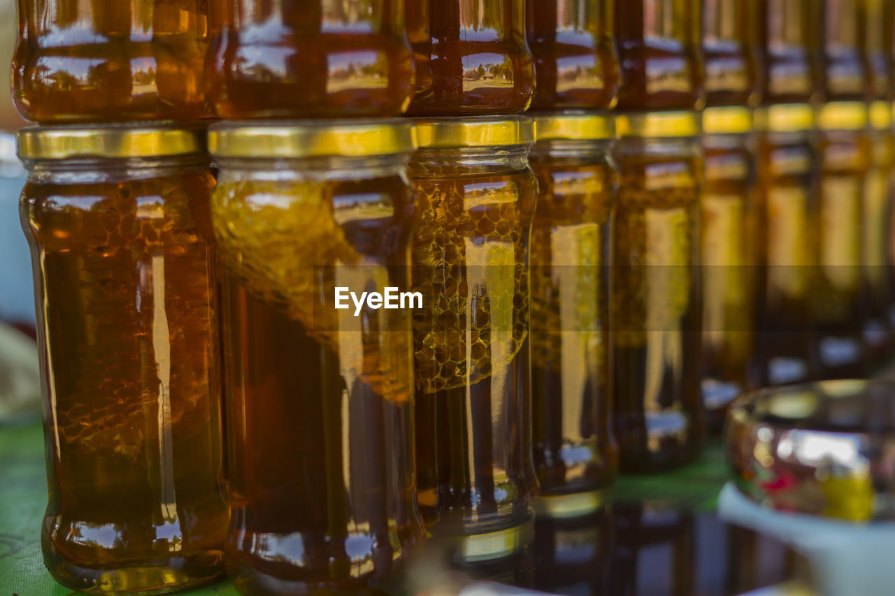 CLOSE-UP OF WINE GLASS BOTTLES ON TABLE