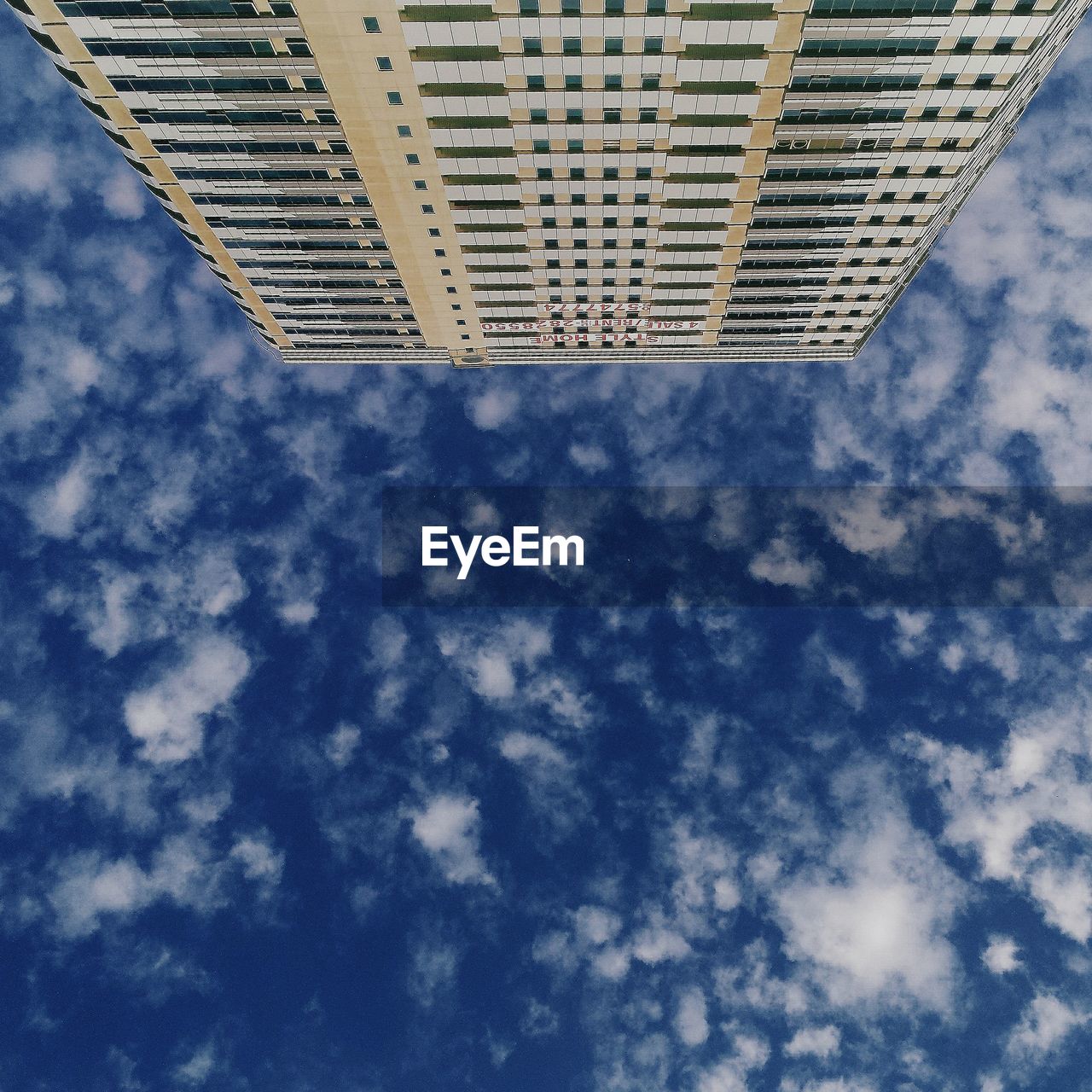 LOW ANGLE VIEW OF CLOUDY SKY OVER BUILDINGS