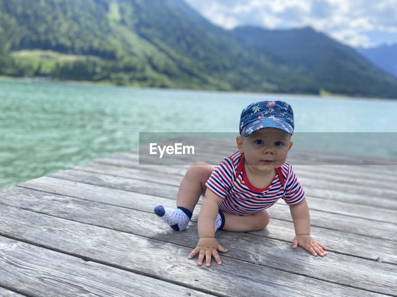 Baby boy on the lake in the austrian alps