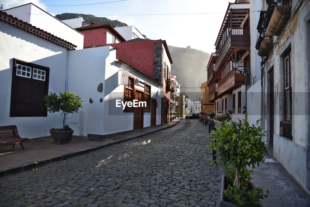 Narrow street amidst buildings in city