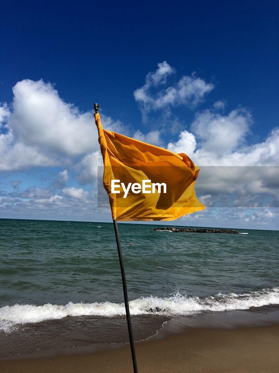 YELLOW UMBRELLA ON BEACH