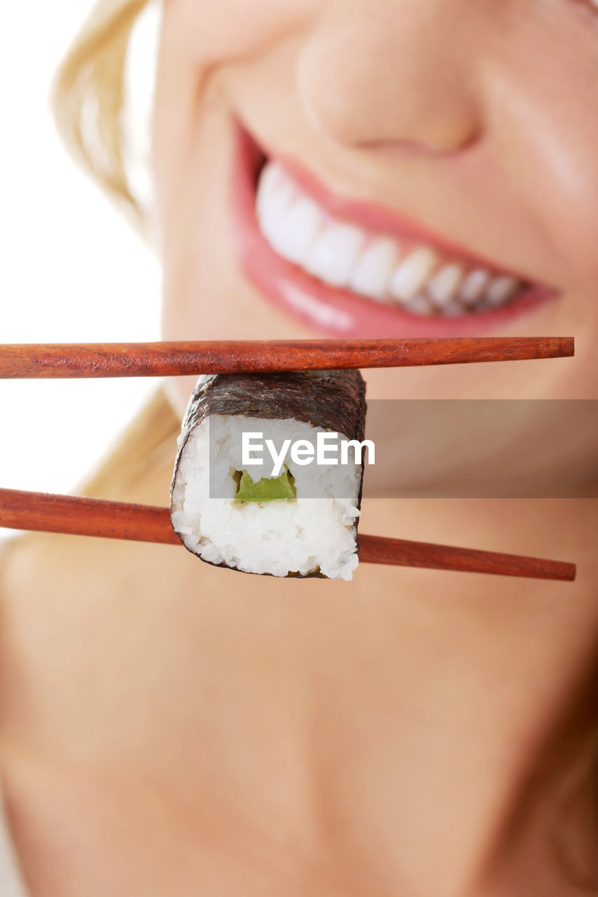 Midsection of woman having sushi