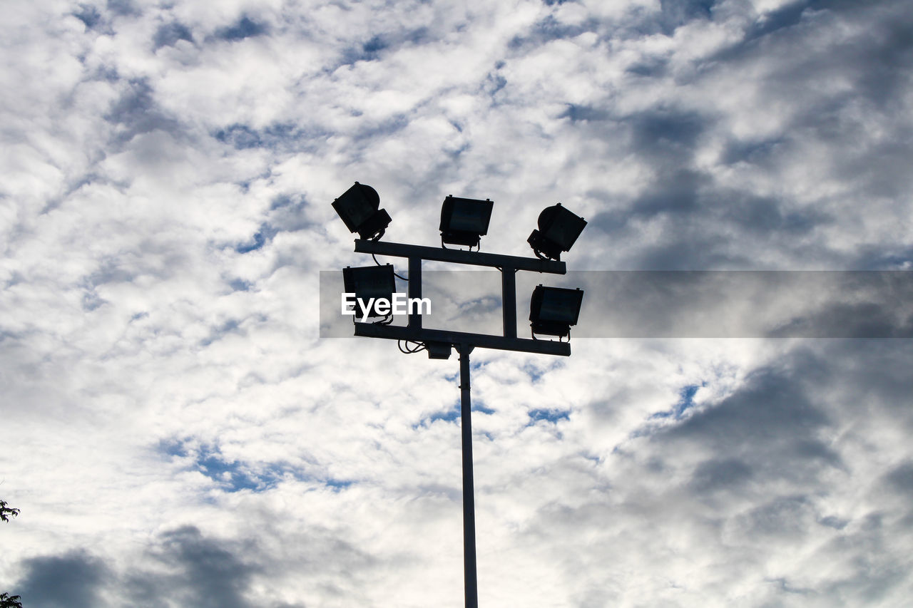 Low angle view of street light against cloudy sky