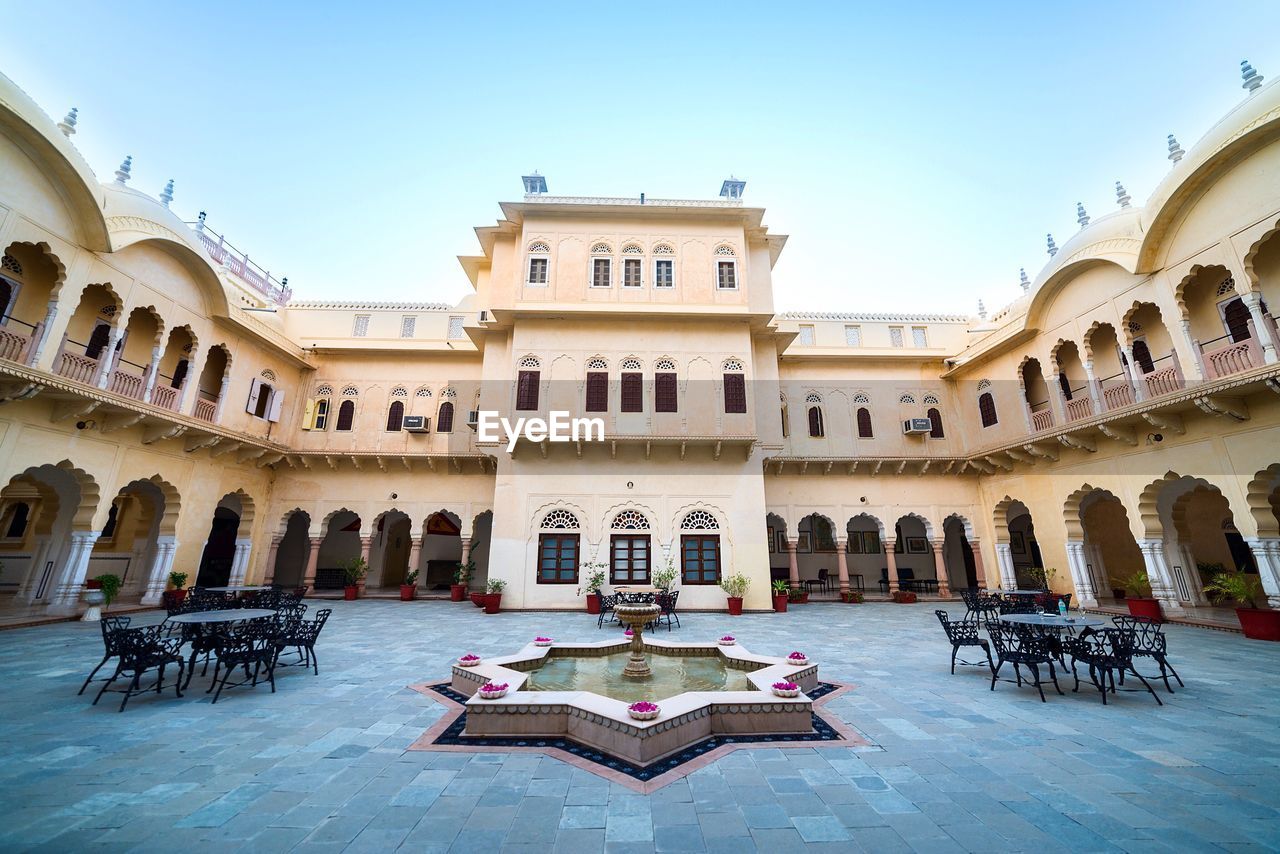 Empty chairs and tables in courtyard at alsisar mahal