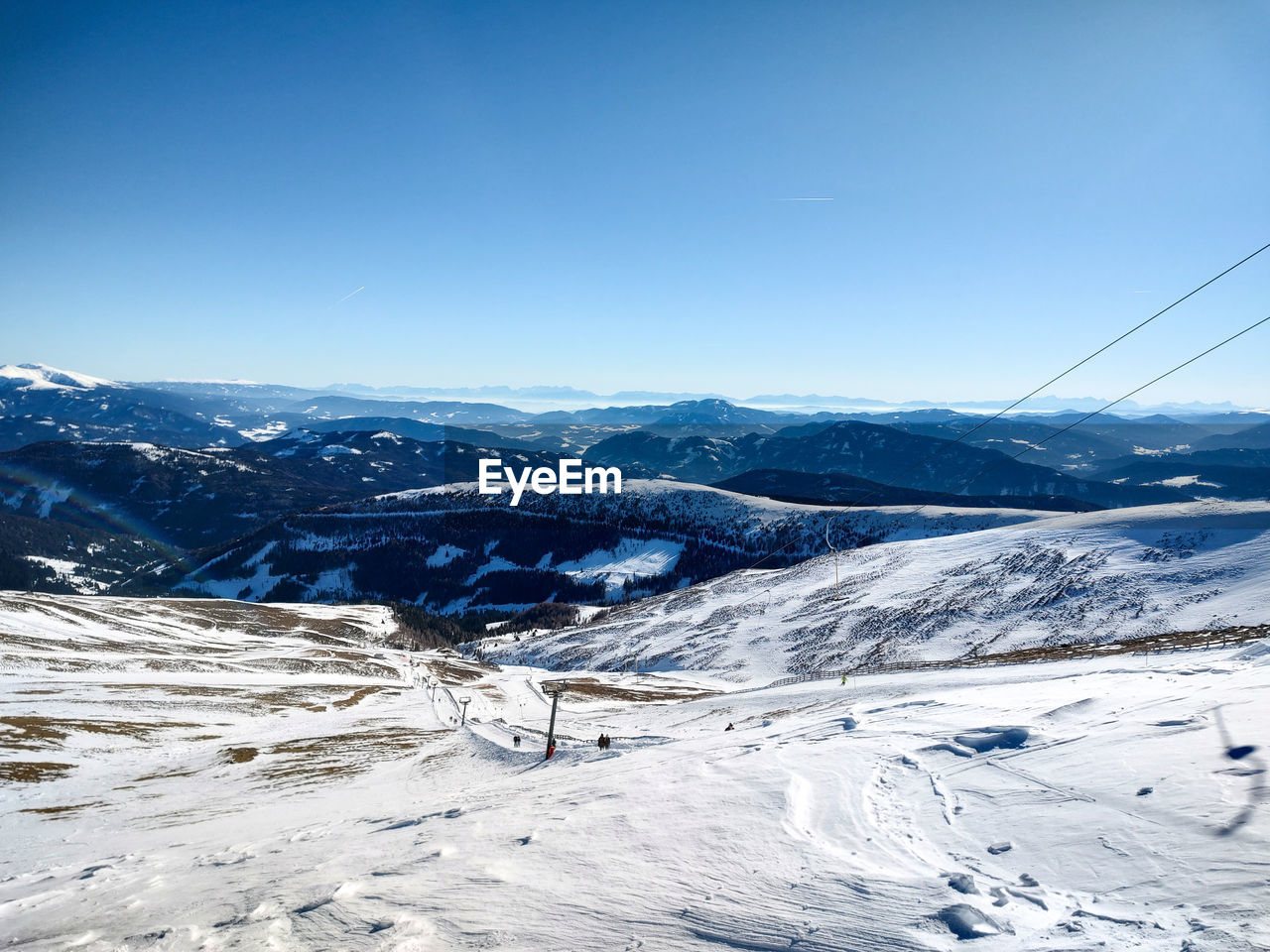 snow, winter, cold temperature, environment, scenics - nature, mountain, landscape, sky, mountain range, beauty in nature, nature, piste, blue, tranquil scene, tranquility, clear sky, no people, winter sports, day, snowcapped mountain, non-urban scene, travel, white, travel destinations, ski touring, ski mountaineering, ski, outdoors, ski equipment, land, frozen, sunlight, copy space, idyllic, ridge, sunny, horizon over land