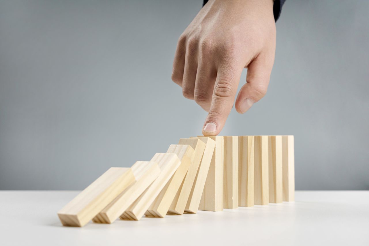 Cropped hand of person touching domino