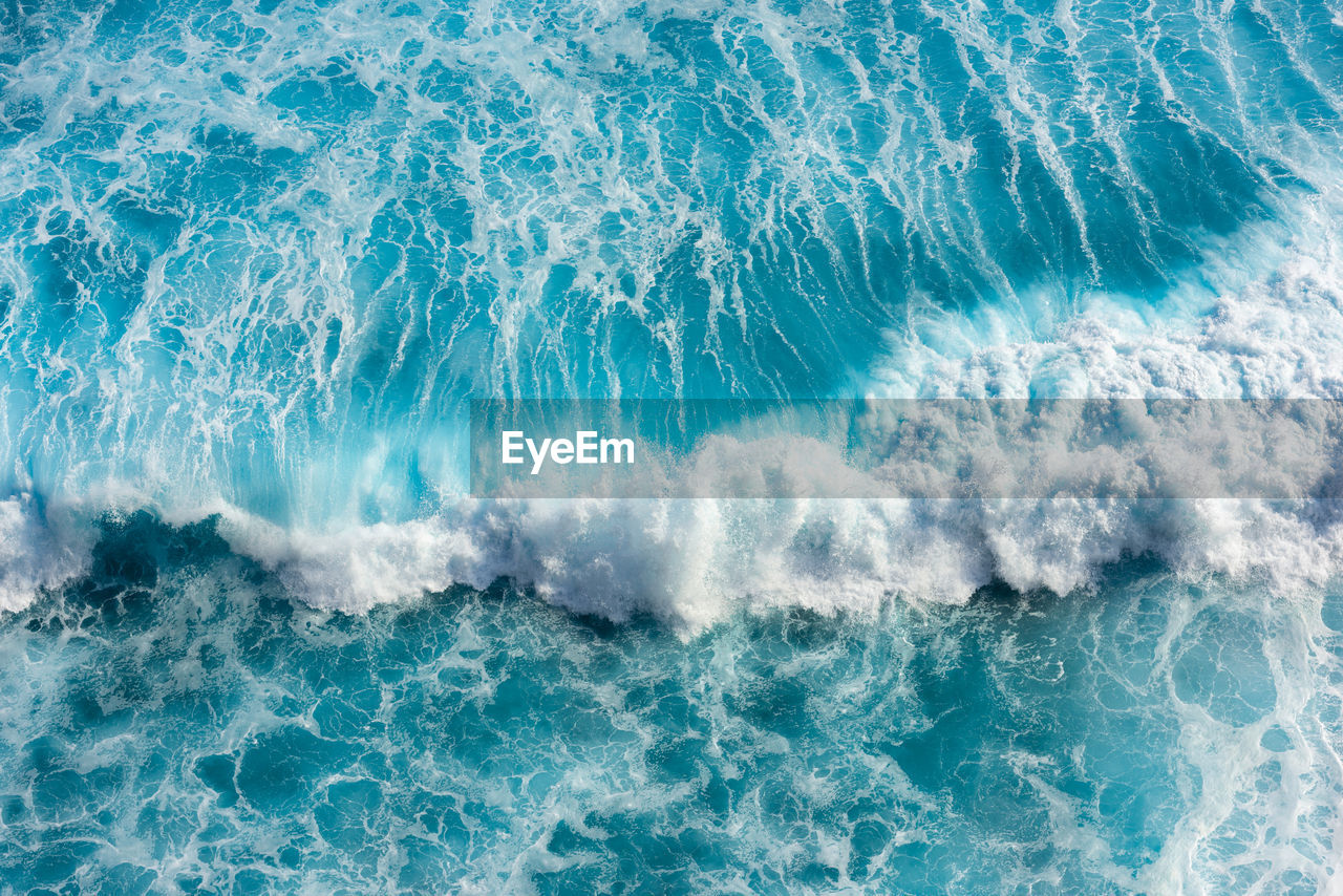 Beautiful sea waves with foam of blue and turquoise in bali,indonesia