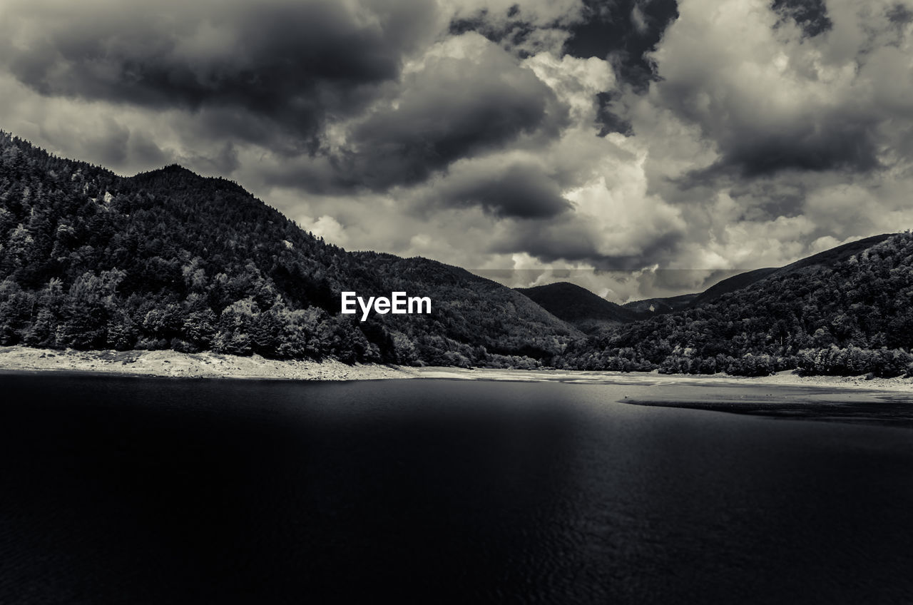 Scenic view of lake and mountains against sky