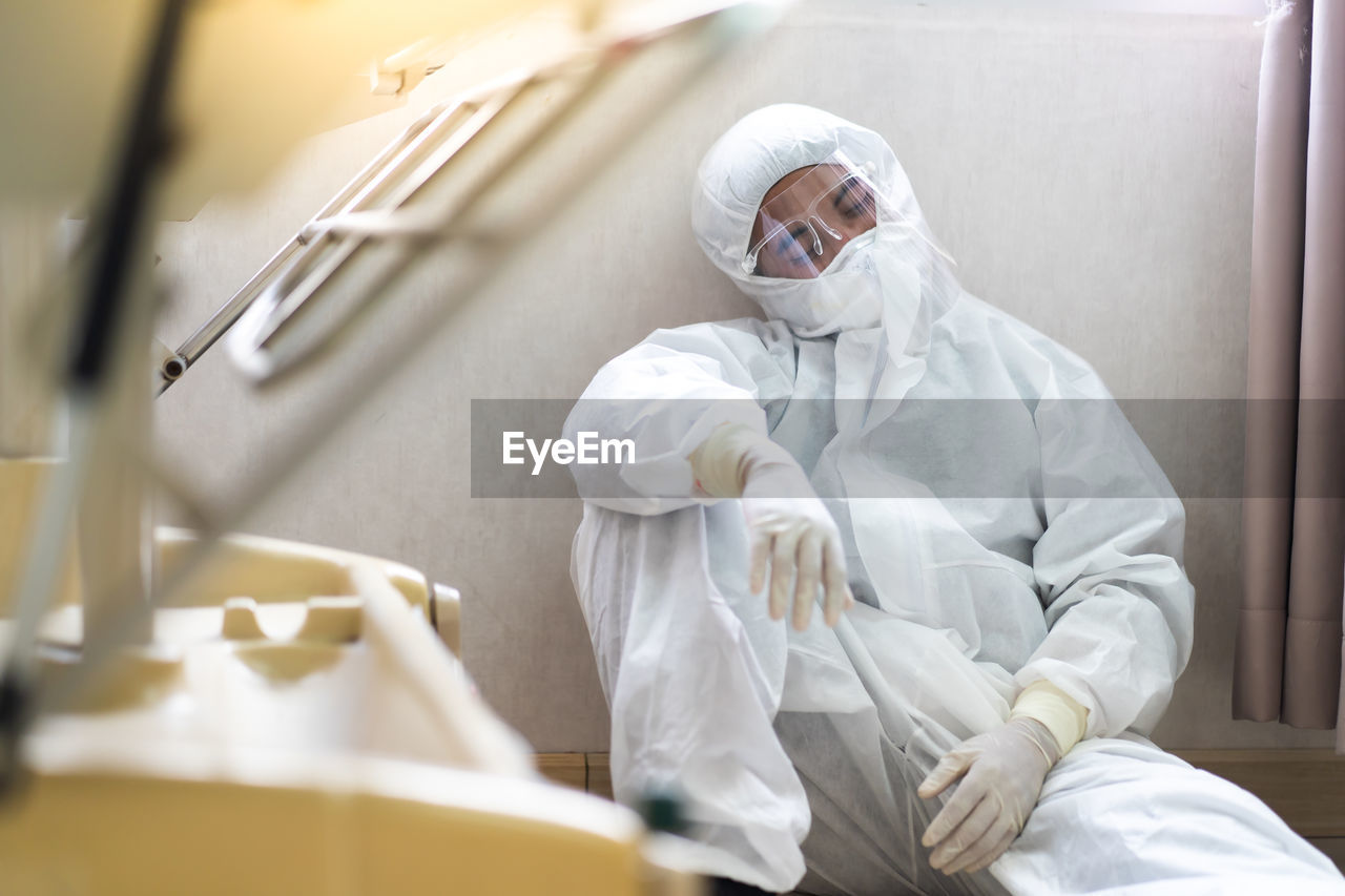 Midsection of man relaxing at hospital