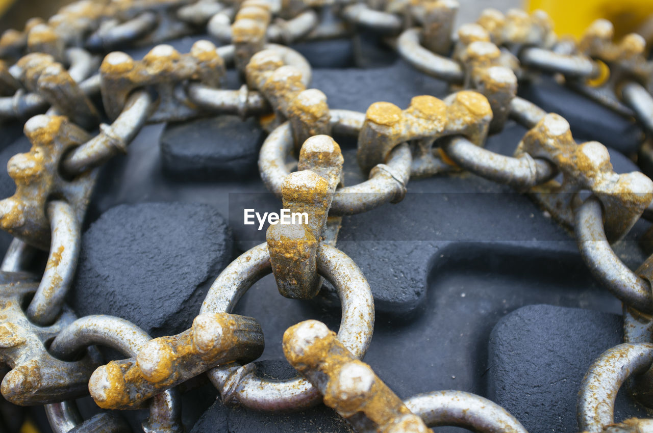 High angle view of rusty chains on tire