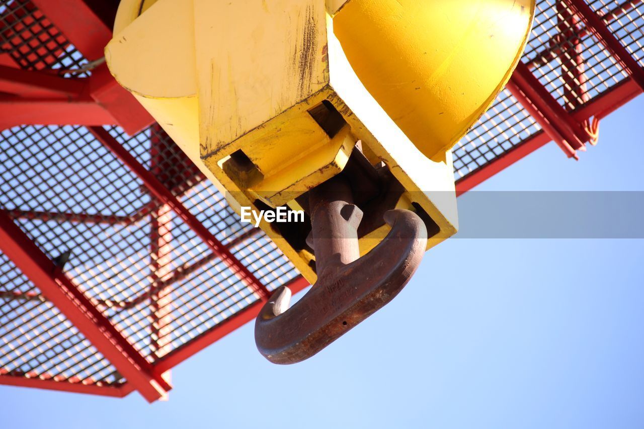 Low angle view of machinery against clear sky