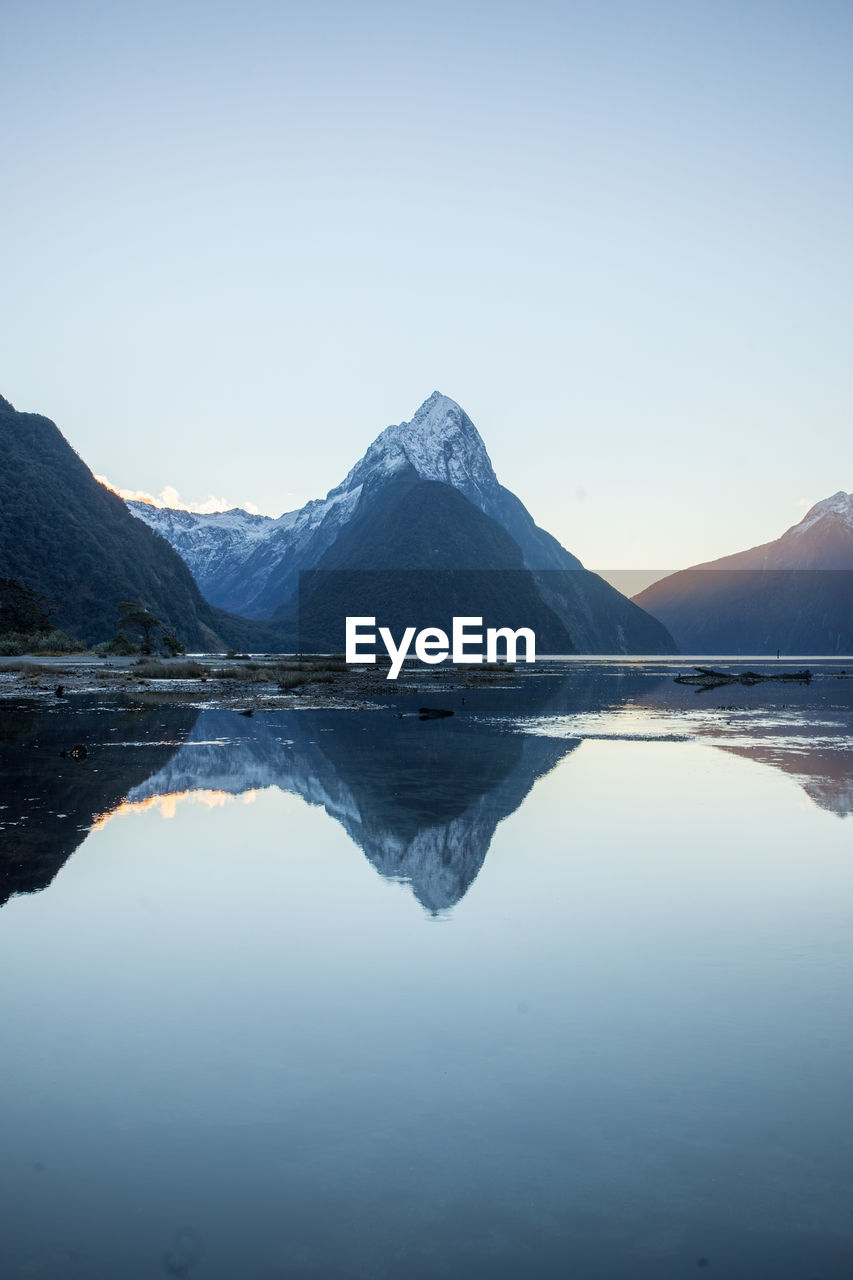 Scenic view of lake and mountains against clear sky