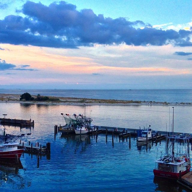 BOATS IN SEA AT SUNSET