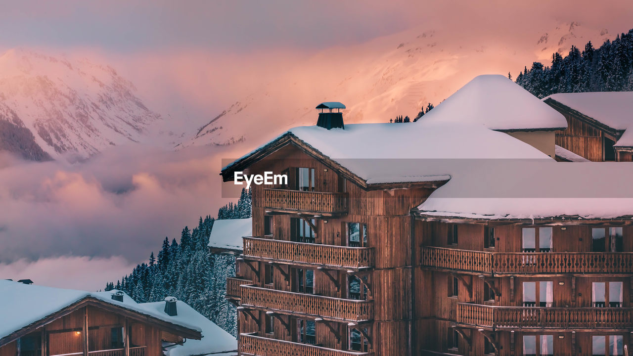 HOUSES AGAINST BUILDINGS DURING SUNSET