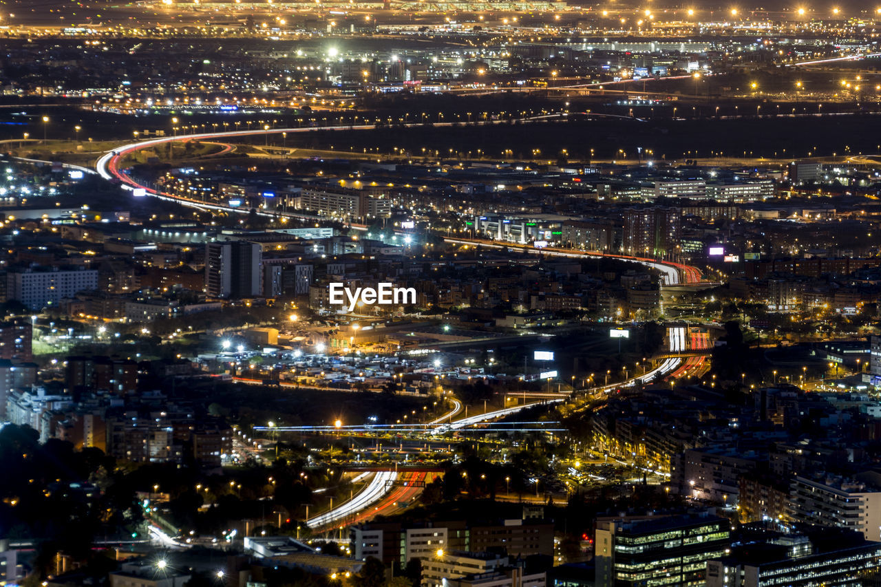 High angle view of illuminated city buildings at night