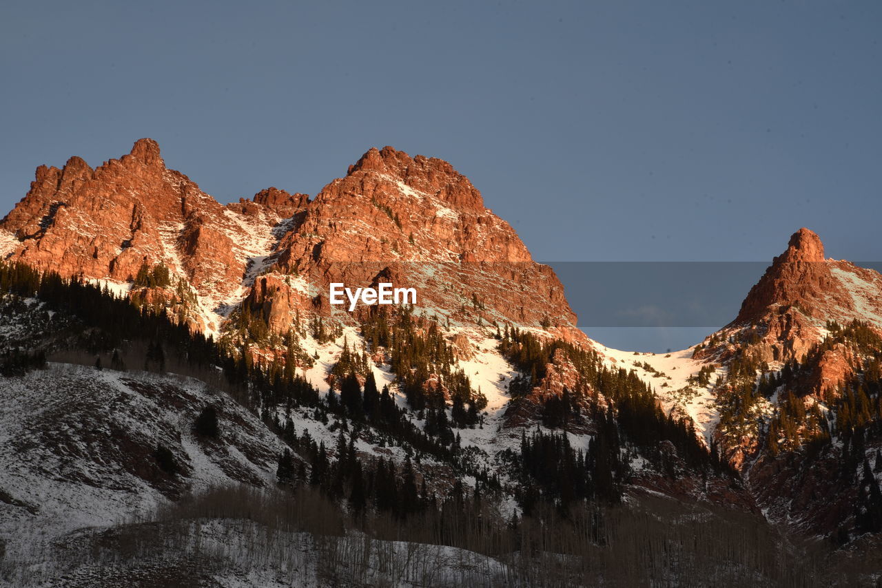 Scenic view of snowcapped mountains against clear sky