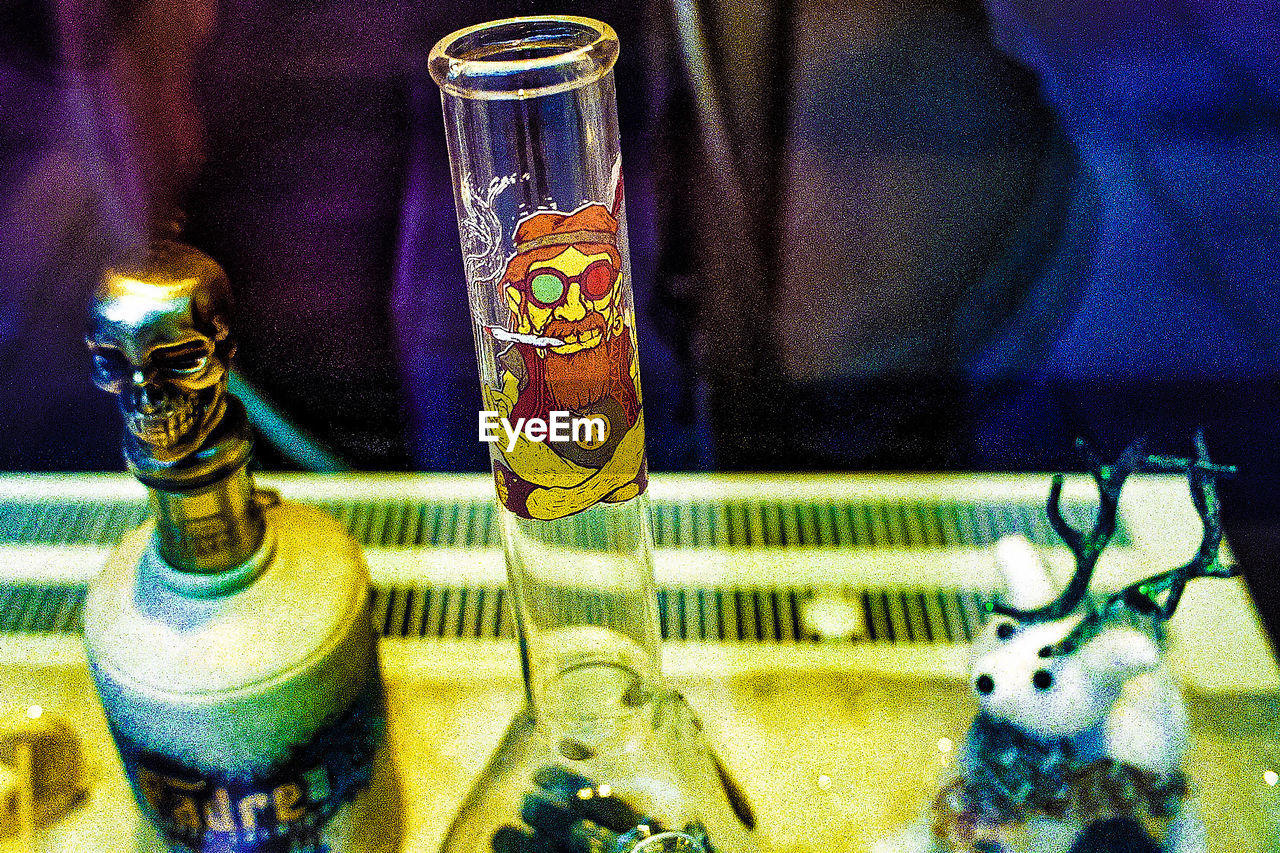 CLOSE-UP OF BEER GLASS WITH BOTTLES