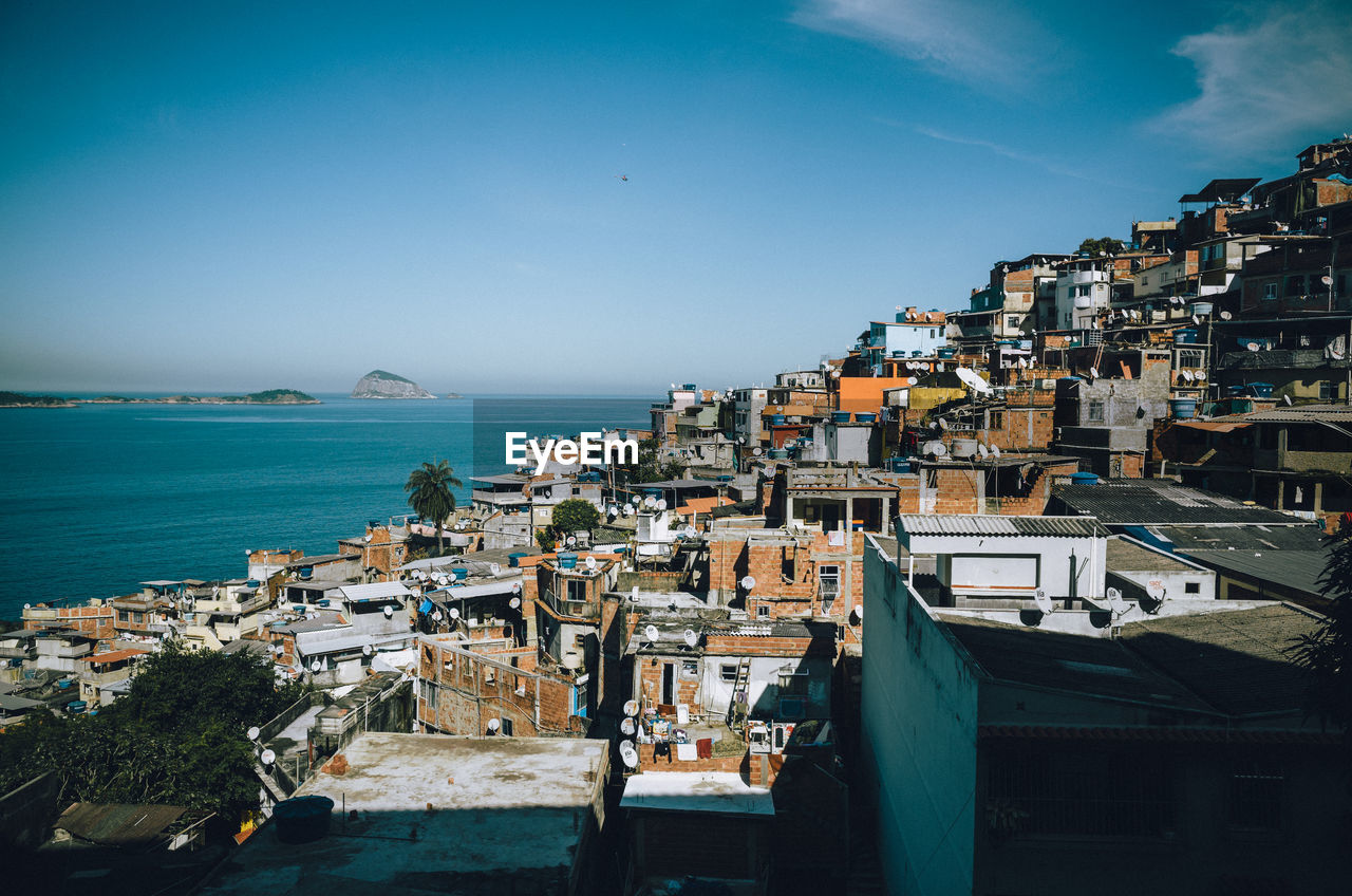 High angle view of brazilian slum by sea against clear sky