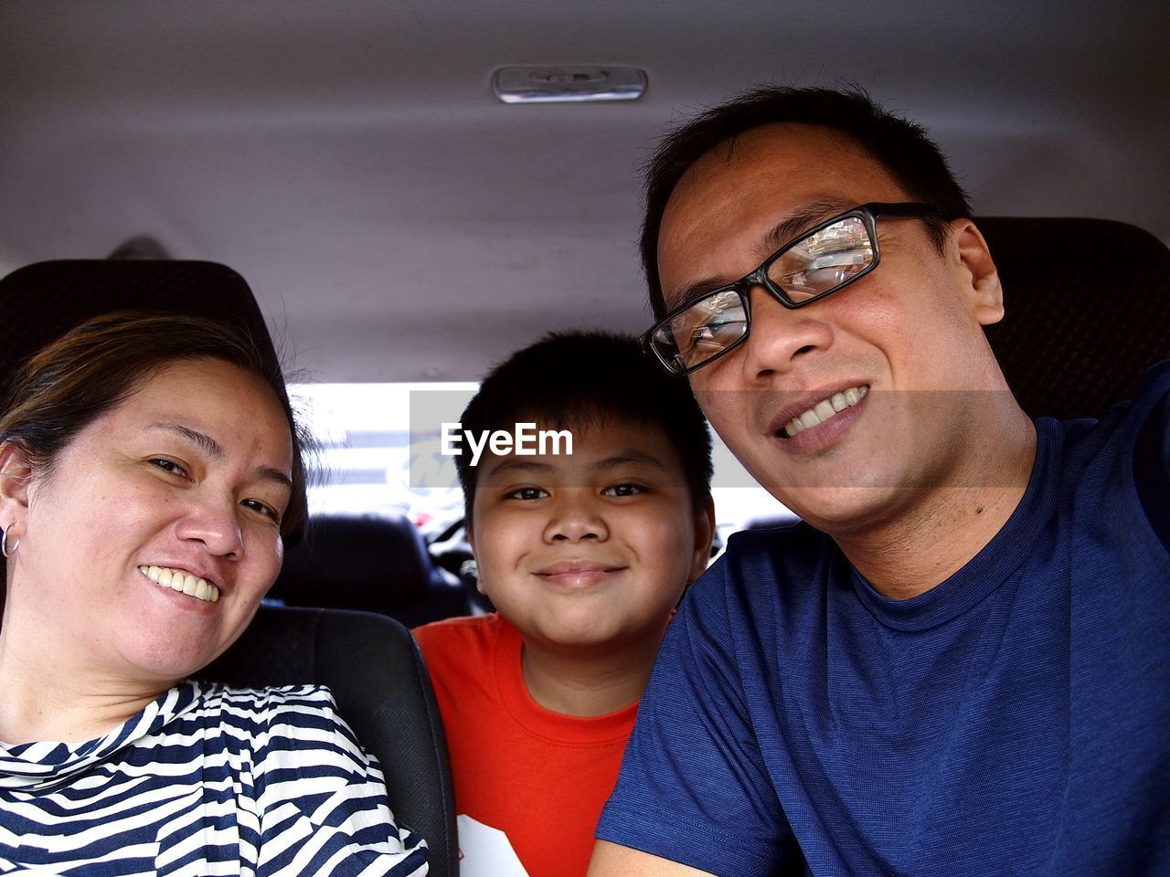 Portrait of smiling family sitting in car