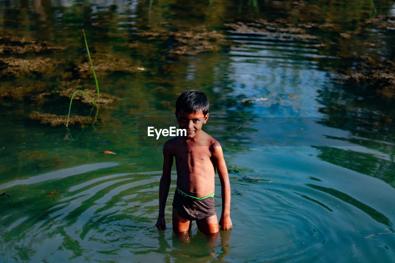 Smiling kid in bluewaters ..and his happiness