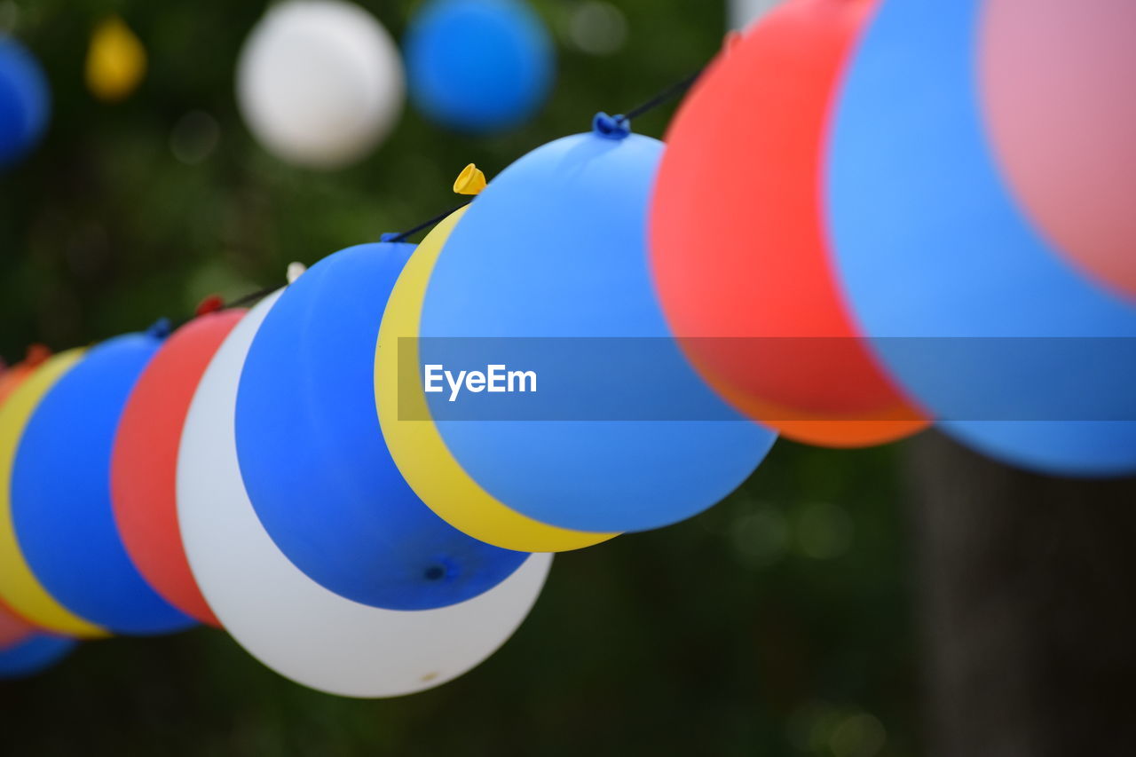 Close-up of colorful balloons hanging outdoors