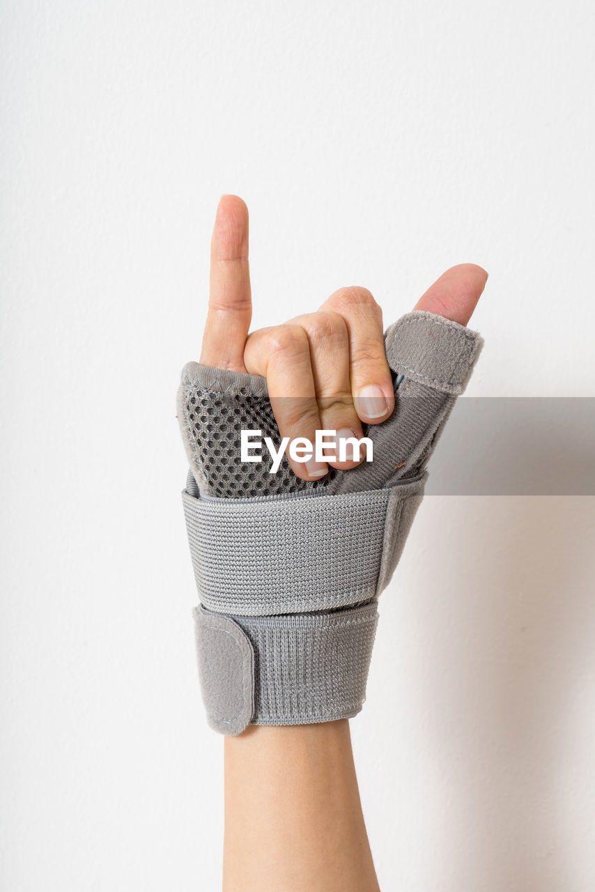 CLOSE-UP OF HUMAN HAND ON WHITE
