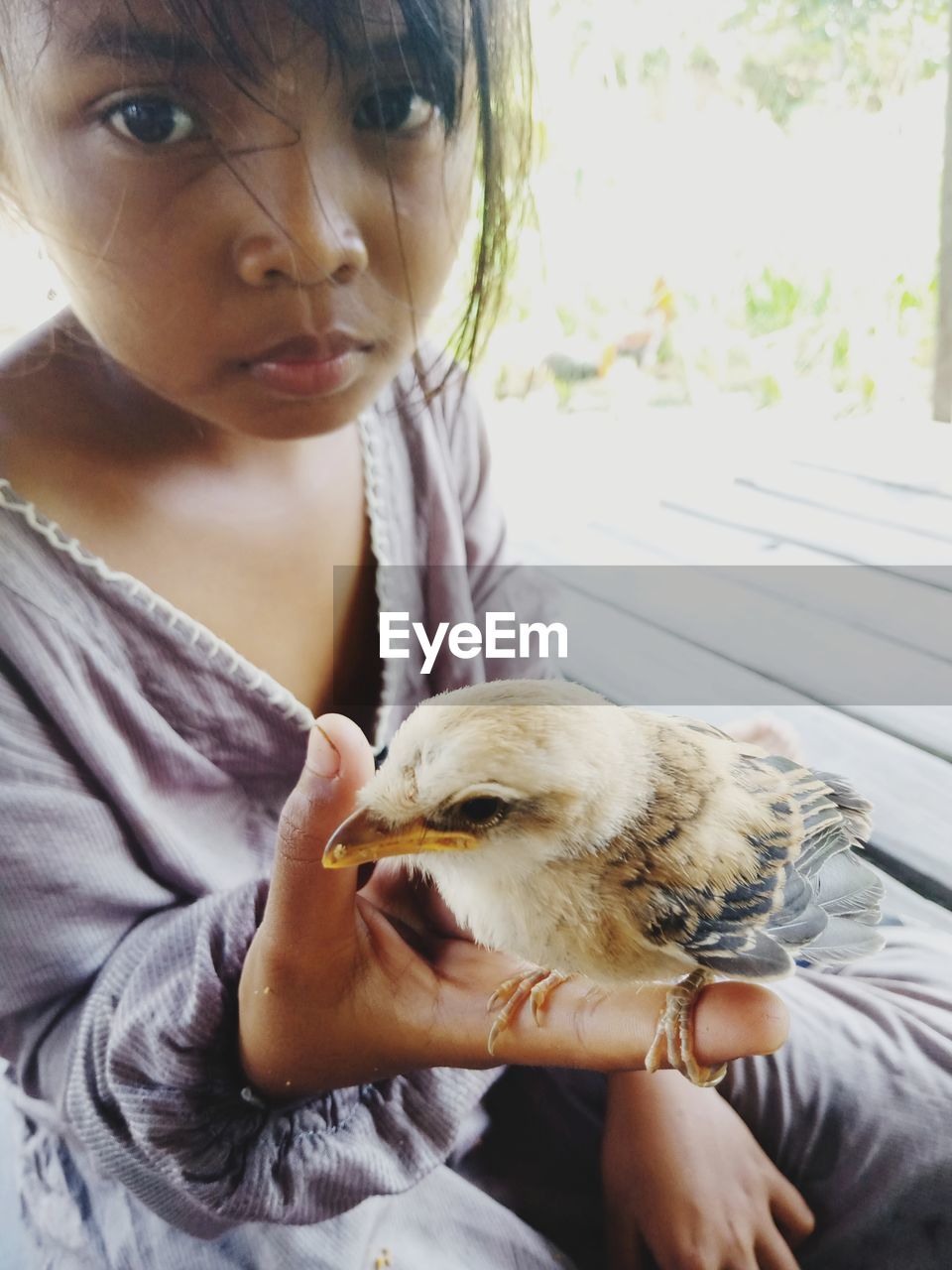 Portrait of girl with sparrow