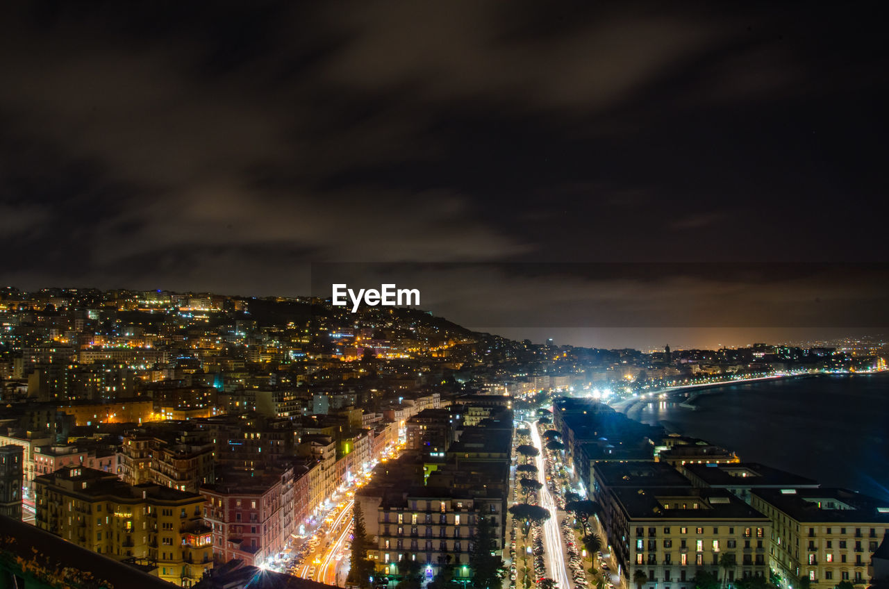 Illuminated cityscape against sky at night