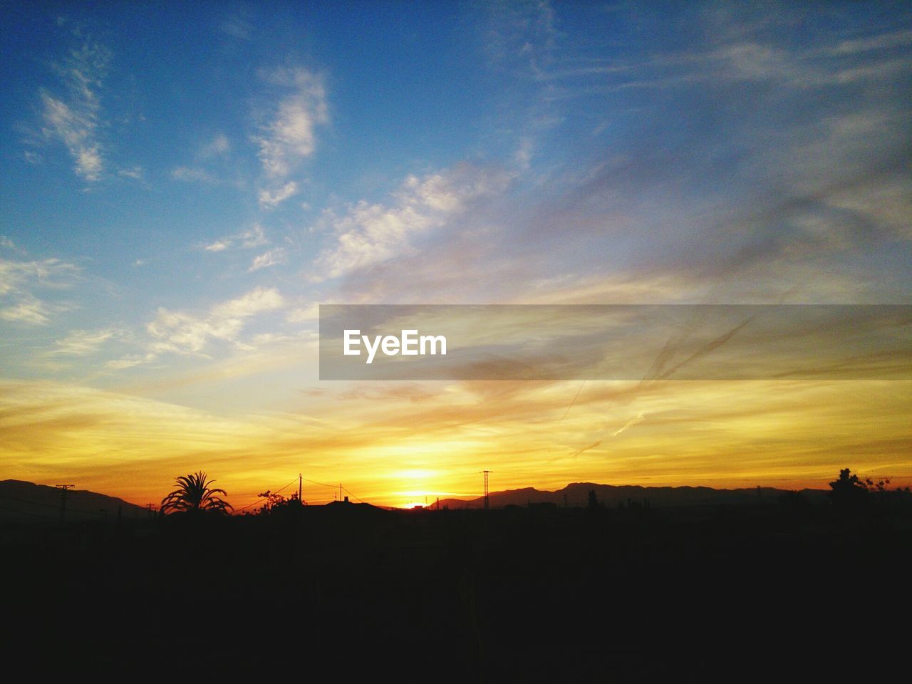 Silhouette landscape against sky during sunset