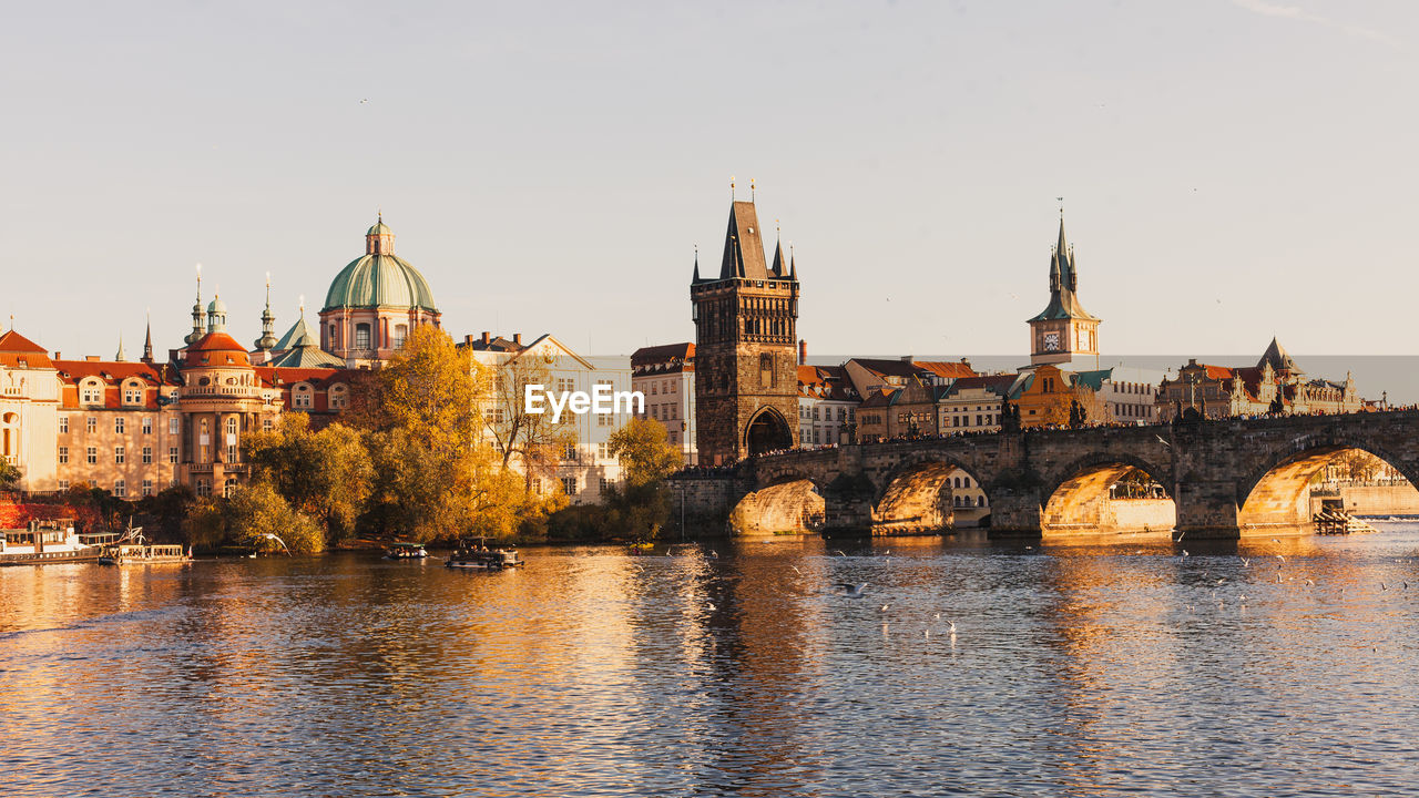 Charles bridge over river against buildings in city