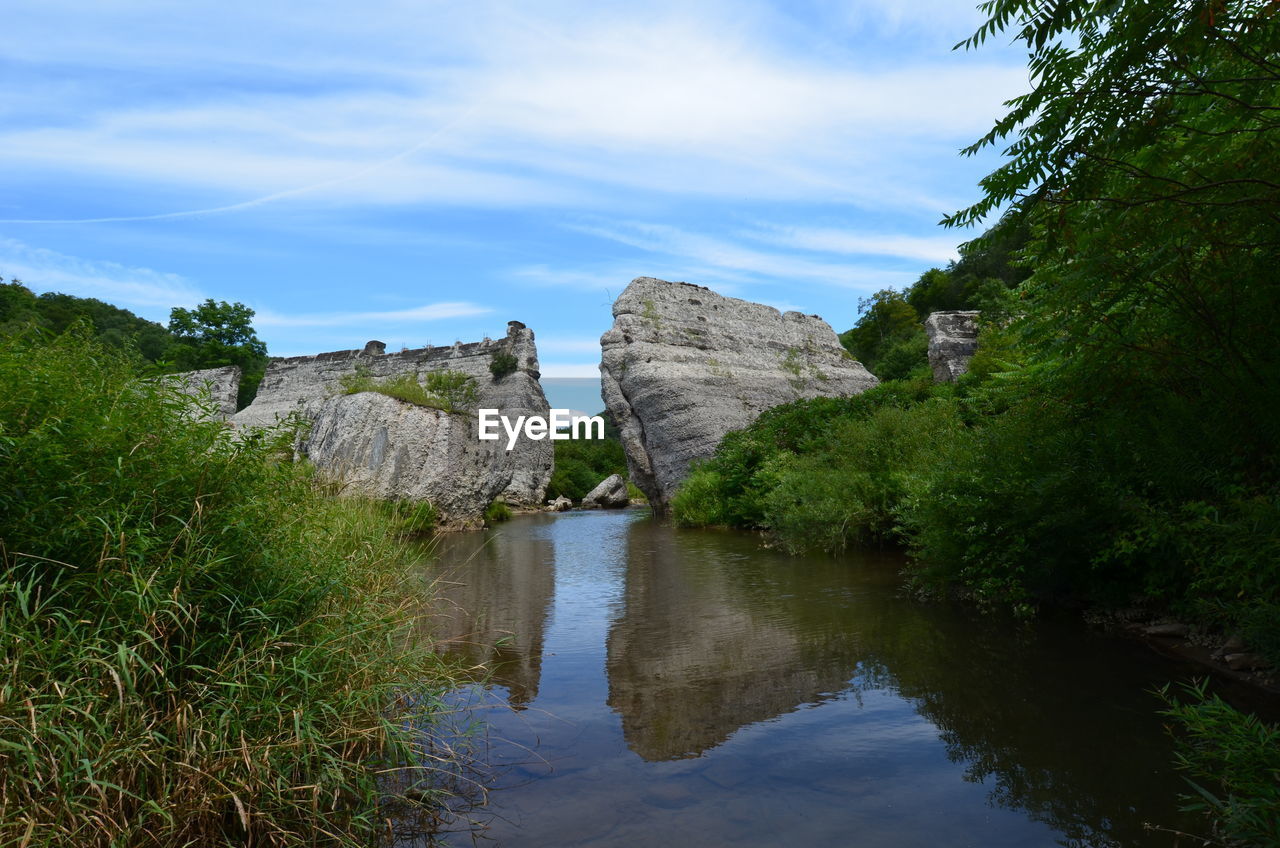 Scenic view of river with rock formations reflection