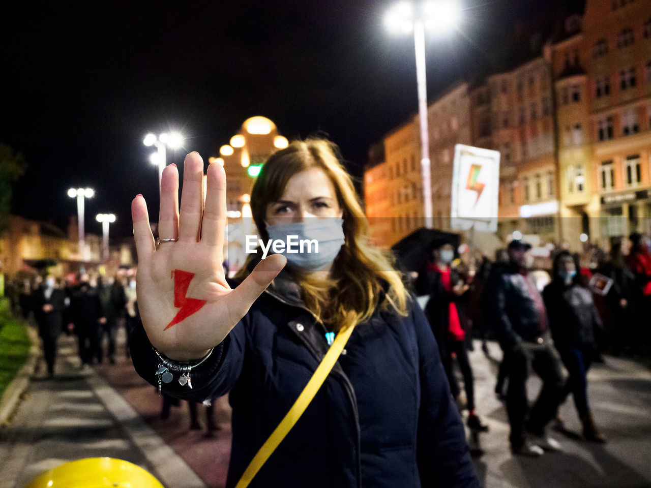 Woman has drawn a sign lightning on hand. women protest against tightening of abortion law. poland.
