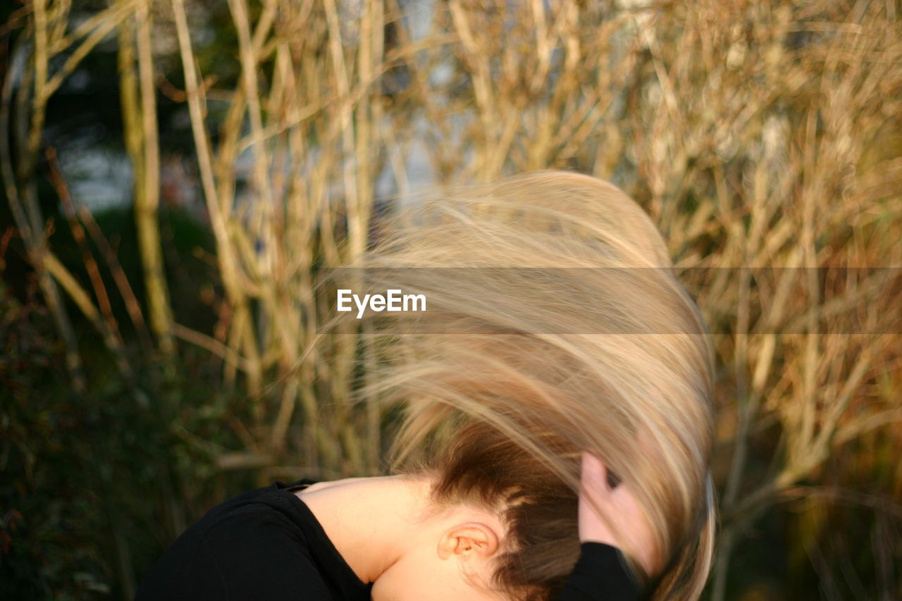 Woman tossing hair outdoors