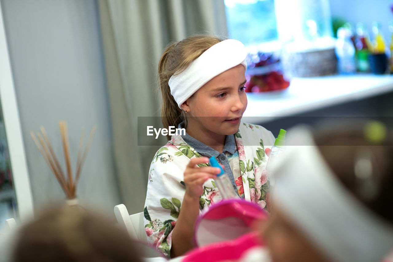 Girl looking away while sitting at spa