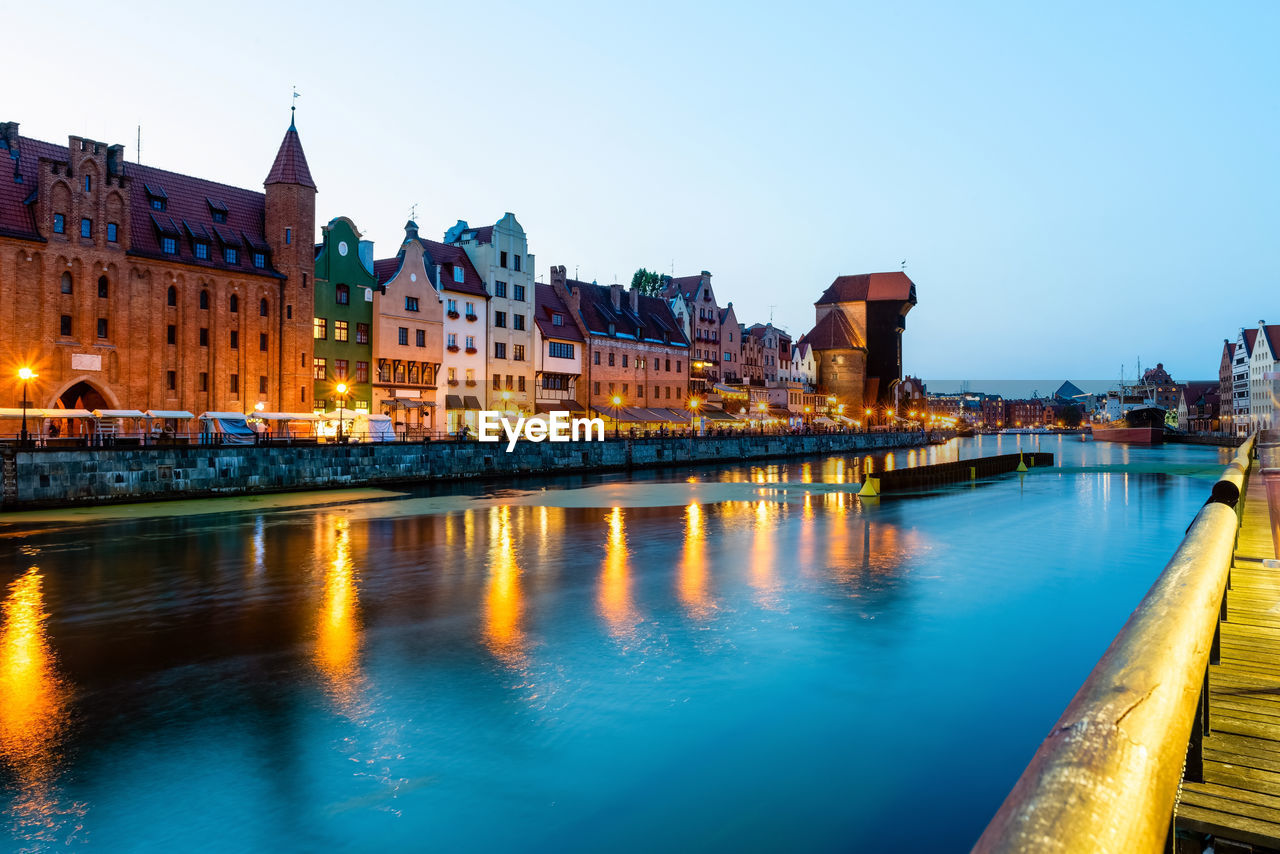 Gdansk night city riverside view. view on famous crane and facades of old gdansk city. poland.