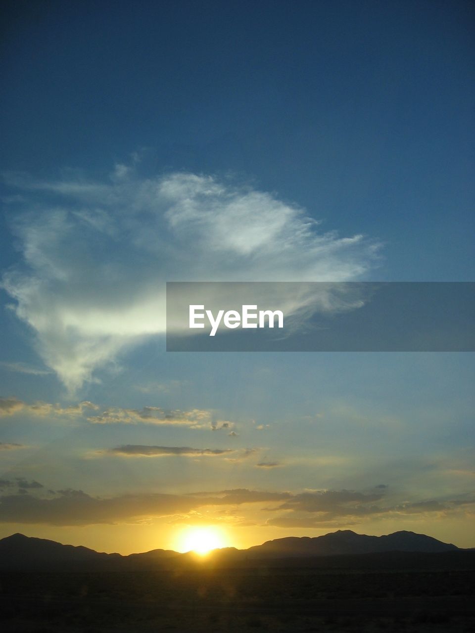 SCENIC VIEW OF SILHOUETTE MOUNTAIN AGAINST SUNSET SKY