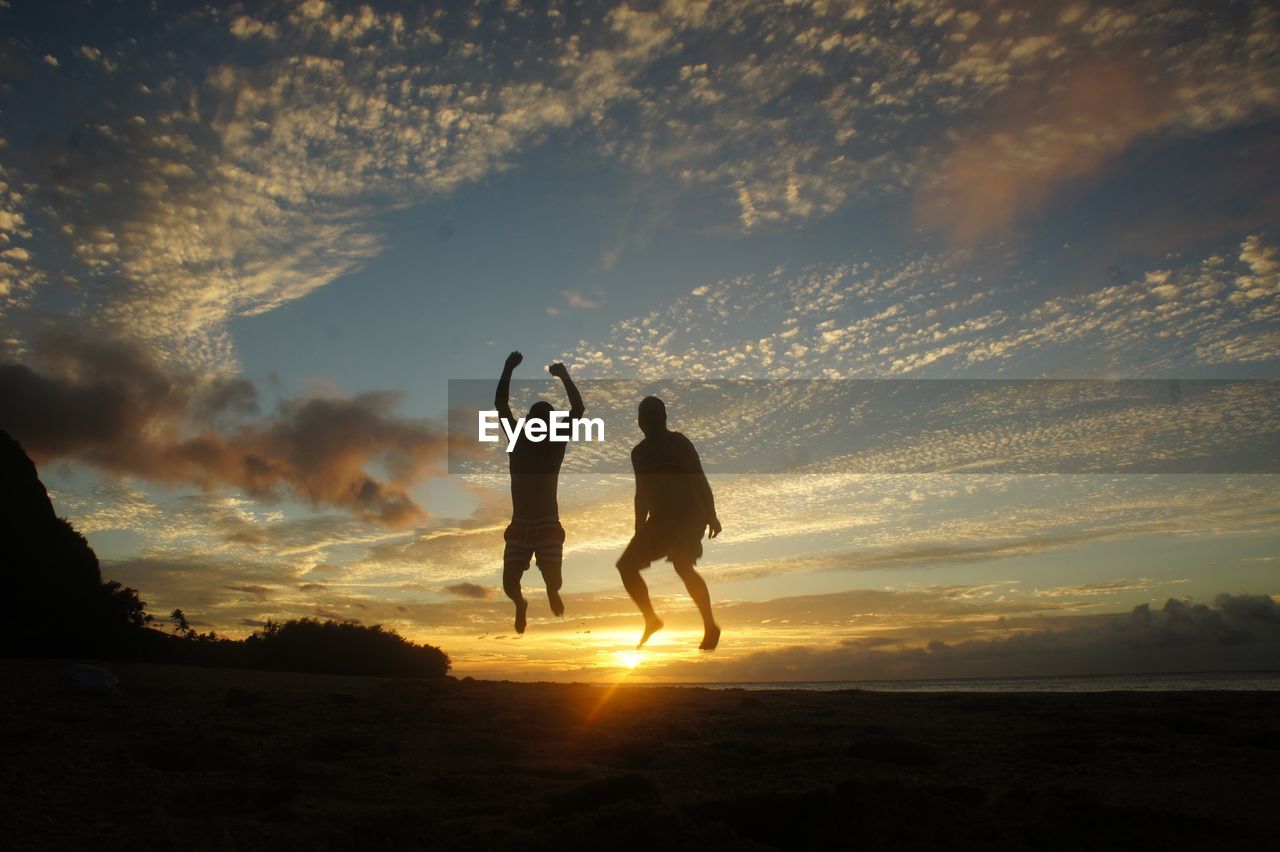 SILHOUETTE OF PEOPLE ON LANDSCAPE DURING SUNSET