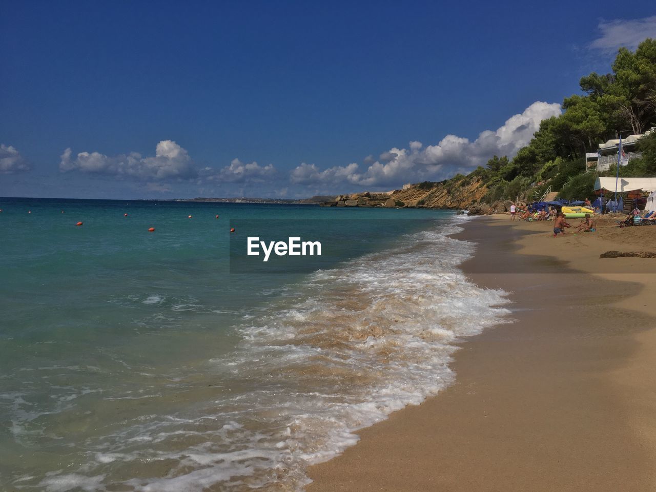 Scenic view of beach against blue sky