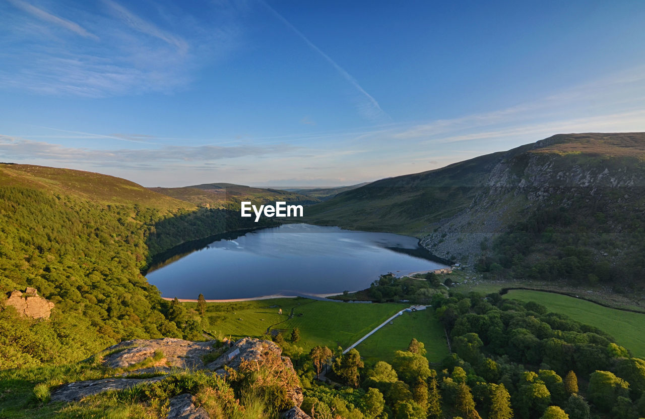 Scenic view of lake and mountains against sky