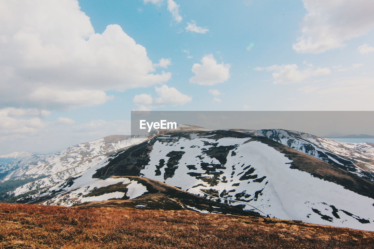 Scenic view of snowcapped mountains against sky