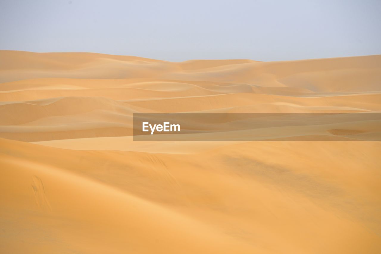 SAND DUNE IN DESERT AGAINST SKY