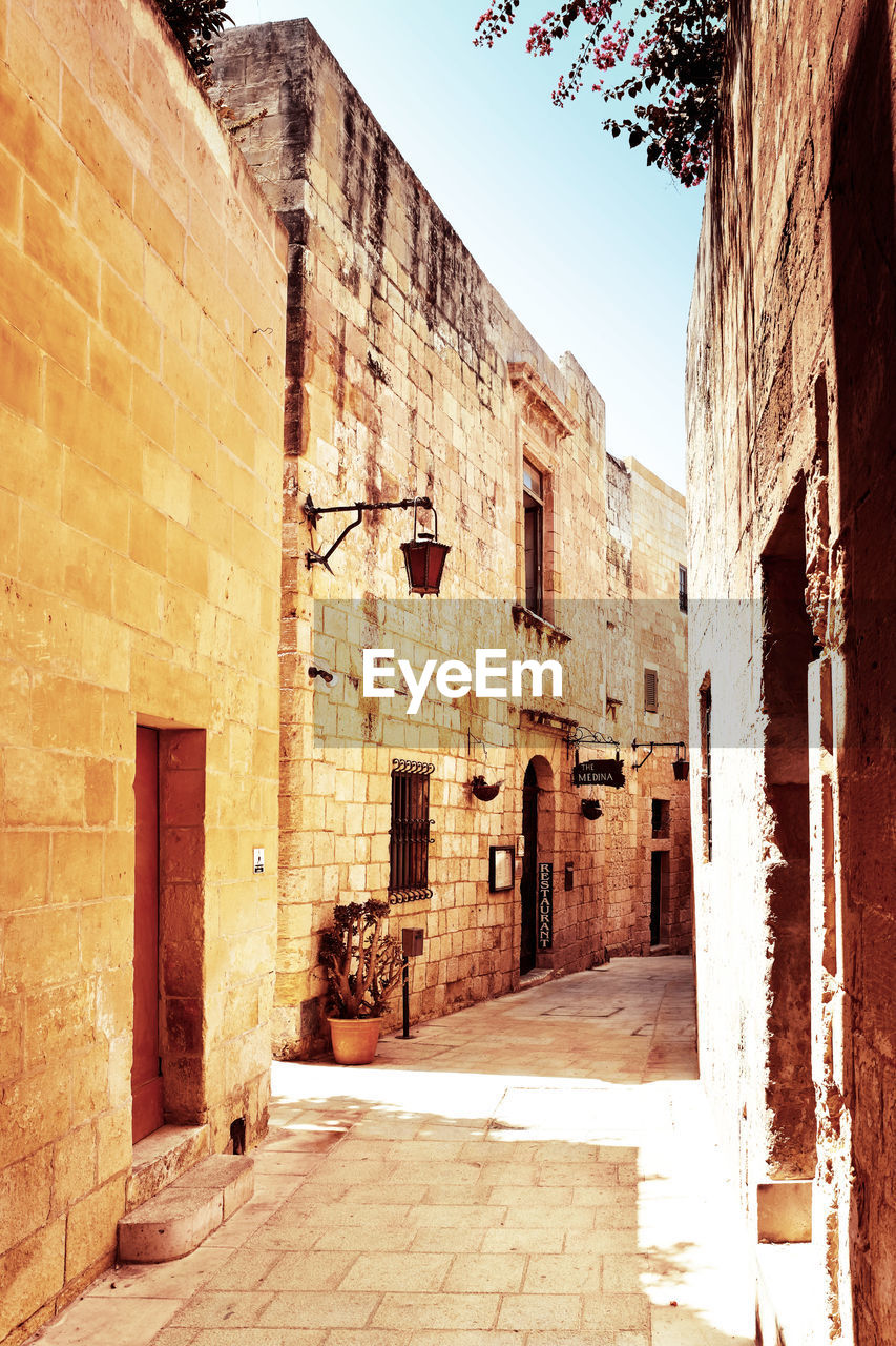 NARROW ALLEY AMIDST OLD BUILDINGS